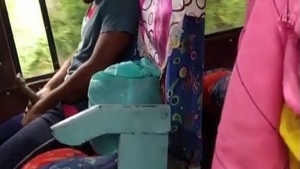 A guy pleasures himself on a bus under the scrutiny of some girls who are recording him