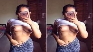 A beautiful woman captures intimate selfies of her breasts for a special someone