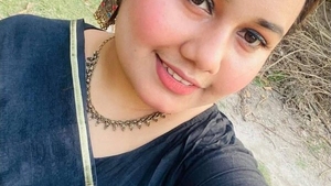 A woman with large breasts unveils herself in a public setting