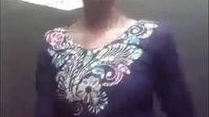 A young Indian woman reveals her body as she removes her clothing on camera