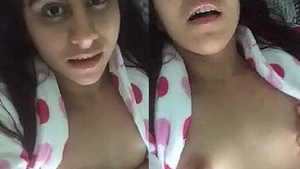 A young woman fondles her breasts and touches her vagina on camera
