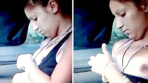 A young woman performs oral sex on a man in a car