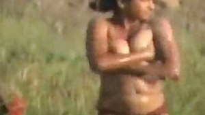 Sexy girl is having a bath naked in the field