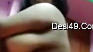 Desi camgirl lifts green dress to impress viewers with huge round tits