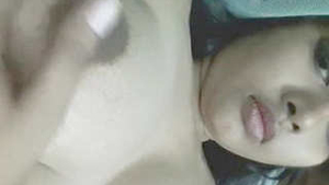 A young woman from India fondles her breasts and vagina with her hands