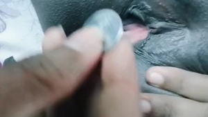 Indian woman inserts coin in her pussy for pleasure