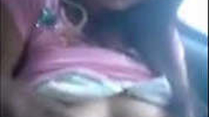 Kanchan, a seductive Indian woman, proudly displays her large breasts and vagina as she performs oral sex in a vehicle